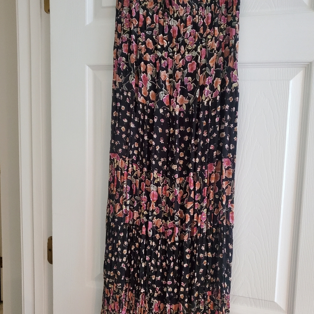 Indira long pleated skirt, black background with mauve and light brown flowers.